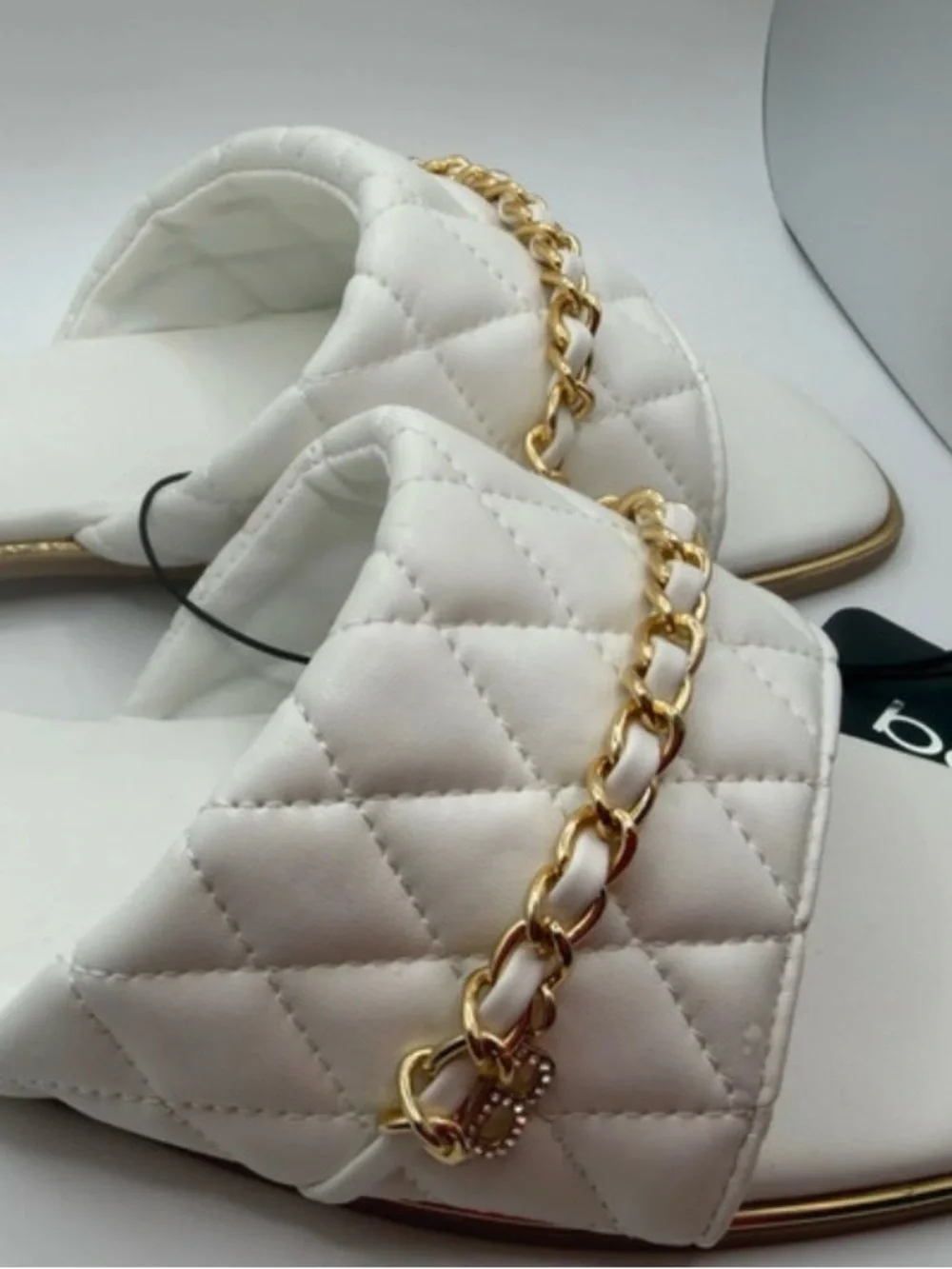 bebe White Quilted Slide Sandals with Gold Chain Accent